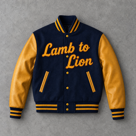 A varsity-style jacket with a navy blue body and mustard yellow leather sleeves, featuring the embroidered text 'Lamb to Lion' across the chest. The jacket is displayed flat against a textured gray background.