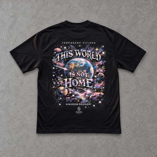 A black short-sleeve t-shirt with the white printed text 'Everything I have, I owe to God.' on the chest, laid flat on a textured gray concrete background.